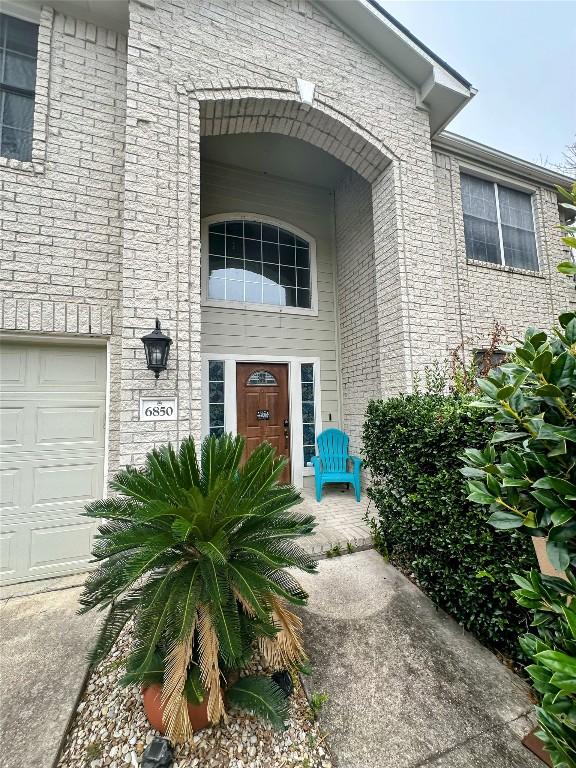 doorway to property with a garage