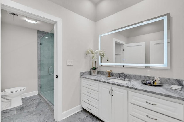 1027 Challenger, Lakeway, TX 78734 - full bathroom with baseboards, marble finish floors, vanity, a shower stall, and toilet