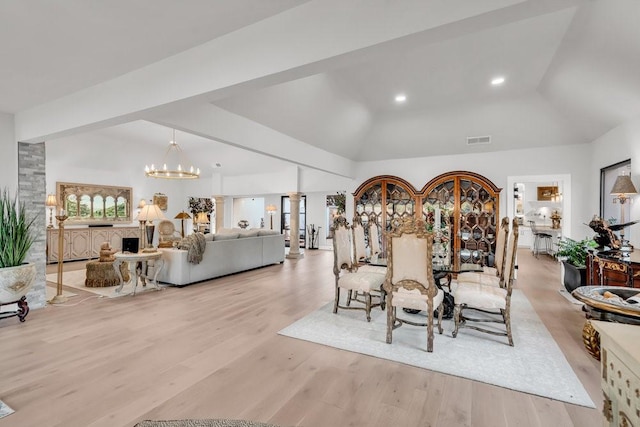1027 Challenger, Lakeway, TX 78734 - dining area featuring a chandelier, wood finished floors, and lofted ceiling
