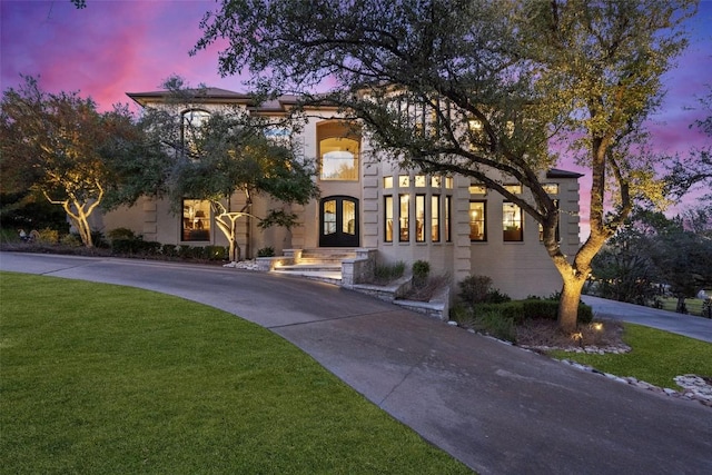 mediterranean / spanish-style house featuring a lawn