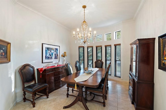 tiled dining space featuring crown molding, a chandelier, and a high ceiling