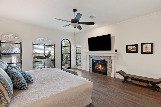 bedroom with crown molding, ceiling fan, and hardwood / wood-style floors