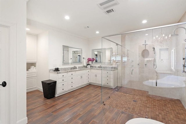 bathroom with hardwood / wood-style flooring, vanity, and separate shower and tub