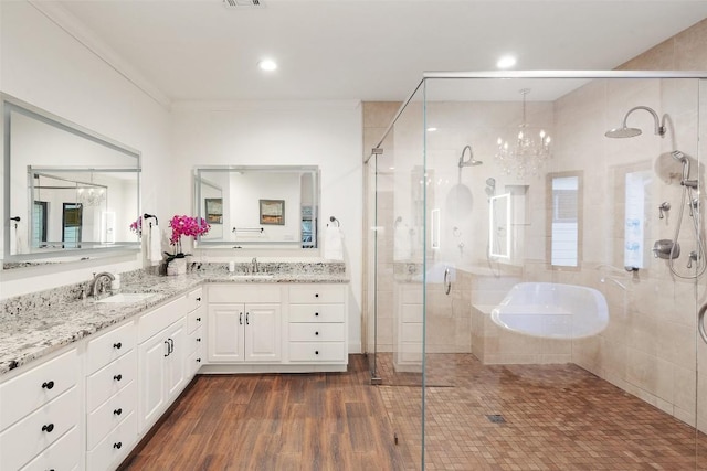 bathroom featuring vanity, hardwood / wood-style floors, a chandelier, and walk in shower