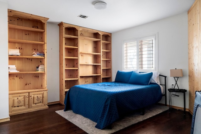 bedroom with dark hardwood / wood-style floors