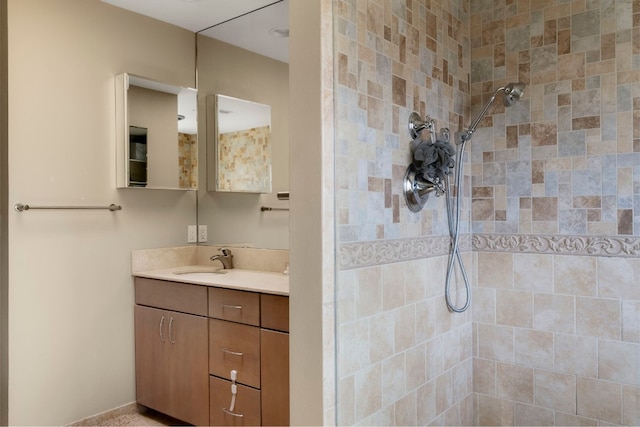 bathroom featuring vanity and a tile shower