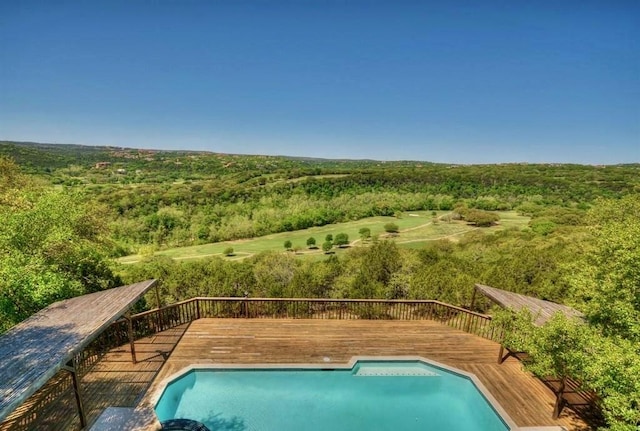 view of swimming pool featuring a wooden deck