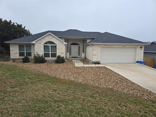 ranch-style home with a garage and a front lawn