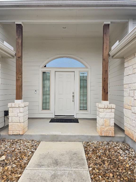 doorway to property featuring covered porch