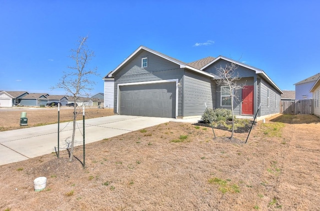 single story home featuring a garage, driveway, and fence