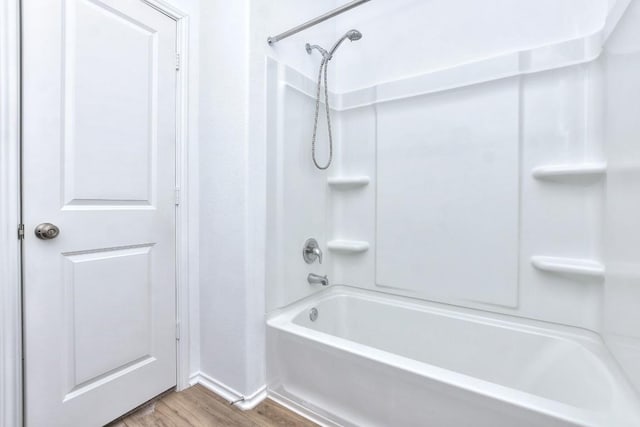 605 Rancho Del Cielo Loop, Jarrell, TX 76537 - bathroom with wood finished floors, shower / washtub combination, and baseboards