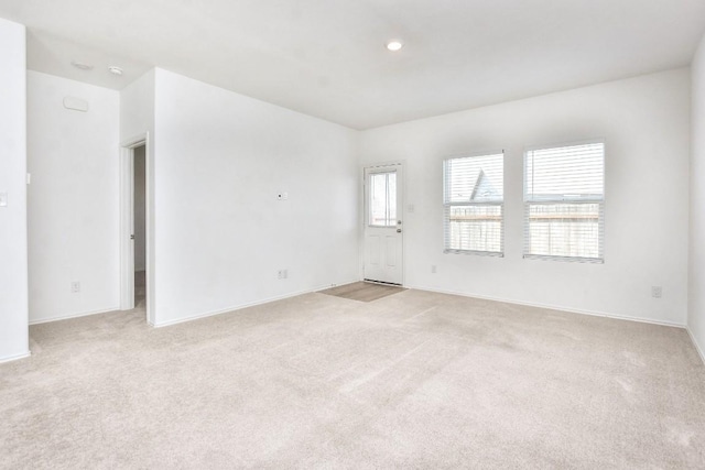 unfurnished room with light carpet and recessed lighting