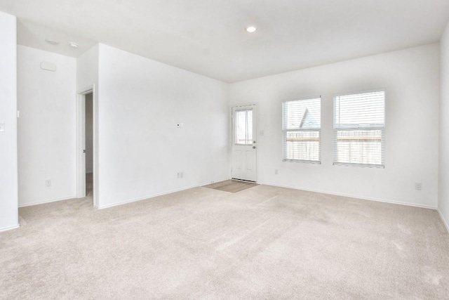 605 Rancho Del Cielo Loop, Jarrell, TX 76537 - empty room featuring light carpet, baseboards, and recessed lighting
