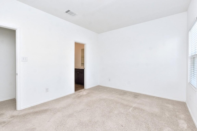 carpeted empty room with visible vents