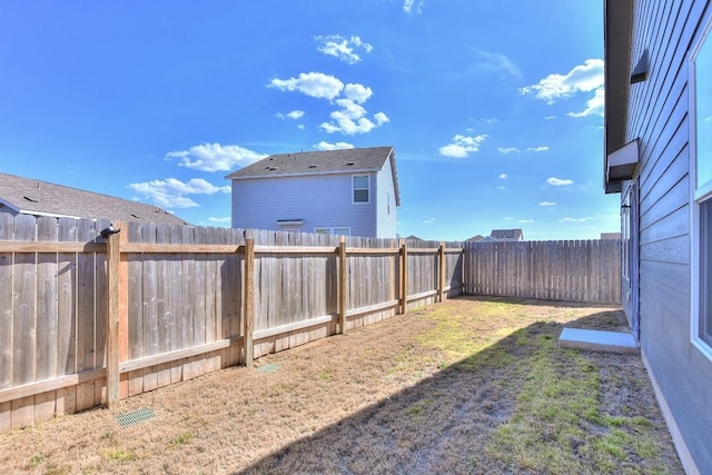 view of yard with a fenced backyard