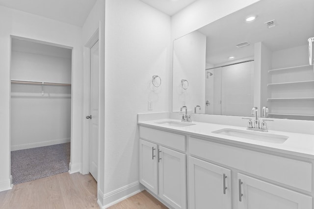 bathroom featuring an enclosed shower, hardwood / wood-style floors, and vanity