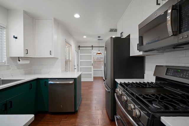 kitchen featuring dark wood-style flooring, stainless steel appliances, recessed lighting, and plenty of natural light