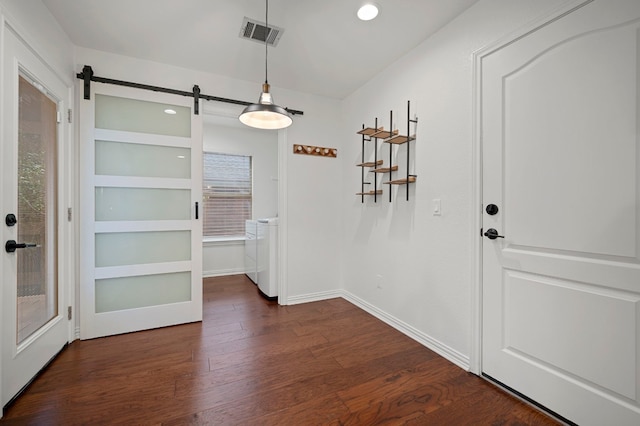 unfurnished dining area with dark wood-style flooring, a barn door, recessed lighting, baseboards, and visible vents