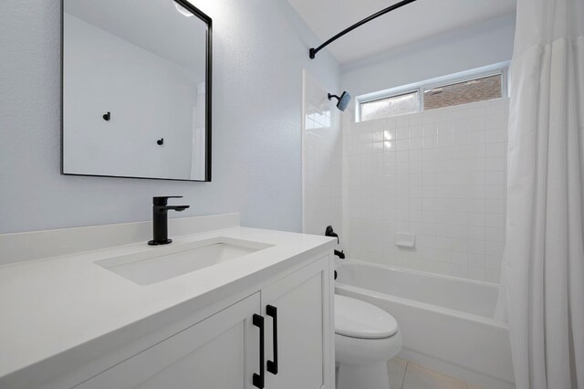 bathroom with vanity, shower / bath combo with shower curtain, and toilet