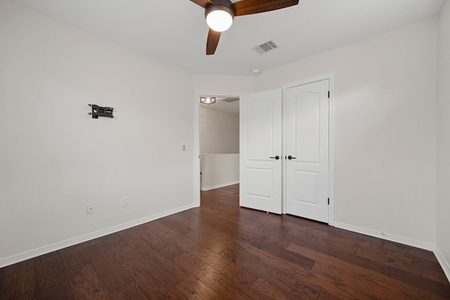 unfurnished bedroom with a ceiling fan, baseboards, wood finished floors, visible vents, and a closet