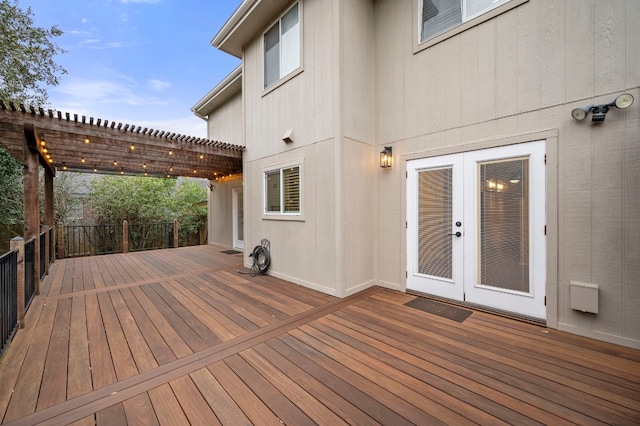 wooden terrace with a pergola and french doors