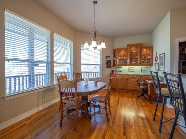 dining room with light hardwood / wood-style flooring and a chandelier