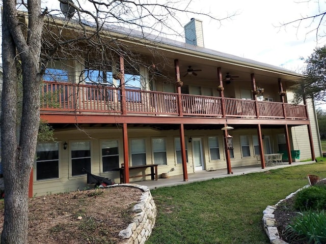 back of property with ceiling fan, a patio area, and a lawn