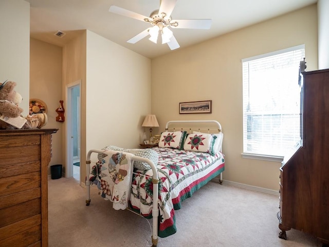 bedroom featuring light colored carpet and ceiling fan