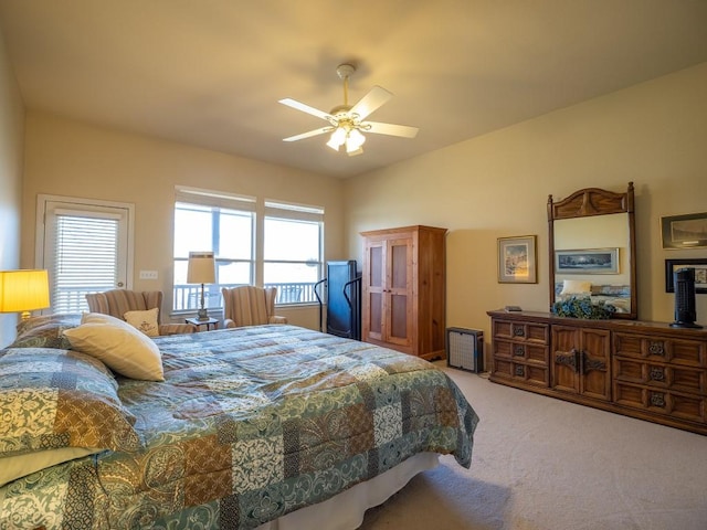 bedroom with ceiling fan, carpet flooring, and vaulted ceiling