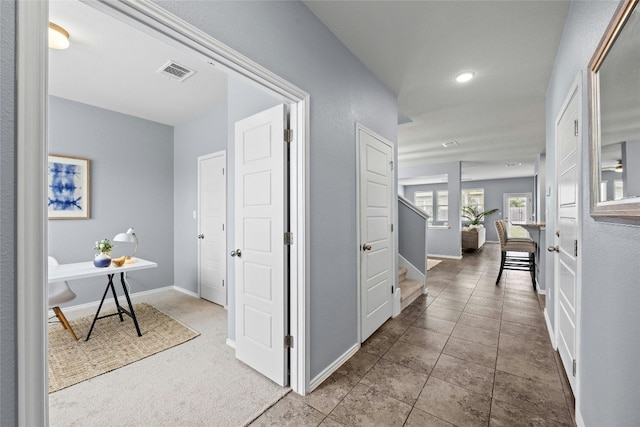 corridor with light tile patterned floors