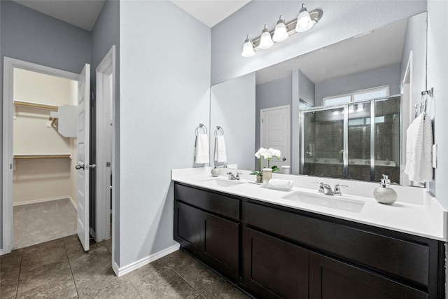 bathroom featuring vanity and a shower with door