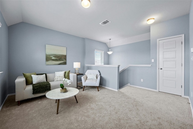 living area featuring lofted ceiling and carpet