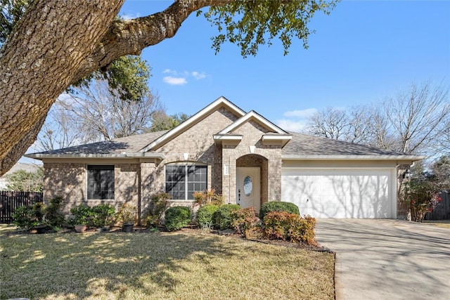 view of front of property featuring a garage and a front lawn