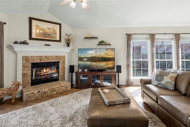 living room featuring hardwood / wood-style floors, vaulted ceiling, and ceiling fan