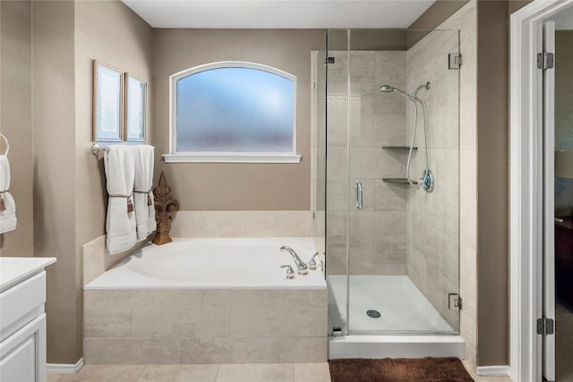 bathroom with vanity and shower with separate bathtub