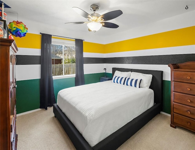 bedroom featuring light carpet and ceiling fan