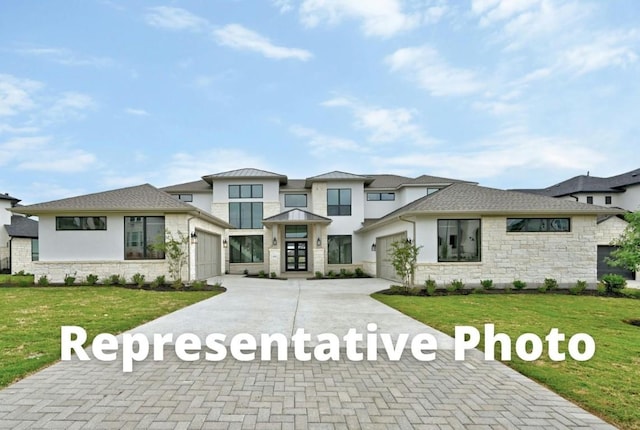 view of front of property featuring a garage and a front lawn