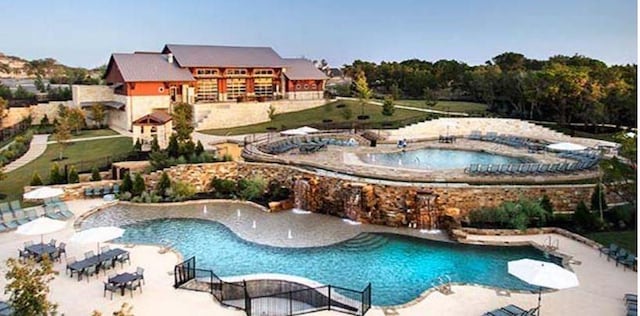 view of swimming pool featuring a hot tub