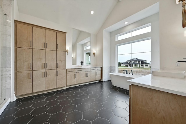 bathroom with high vaulted ceiling, tile walls, vanity, a tub, and tile patterned flooring