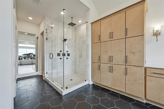 bathroom featuring an enclosed shower and tile patterned floors