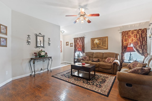 living room with dark wood-type flooring and ceiling fan