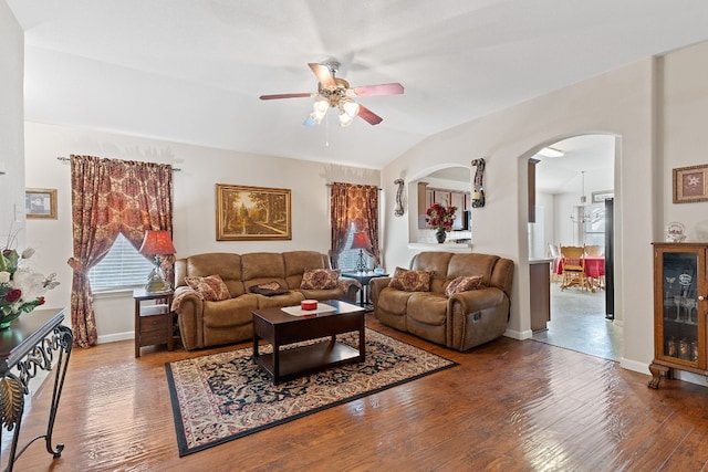 living room with hardwood / wood-style flooring, vaulted ceiling, and ceiling fan