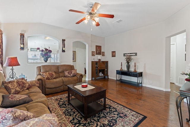 living room featuring dark hardwood / wood-style flooring and ceiling fan