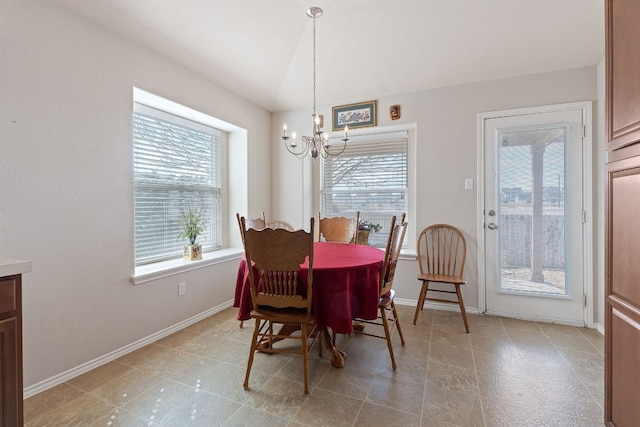 dining area featuring lofted ceiling and an inviting chandelier