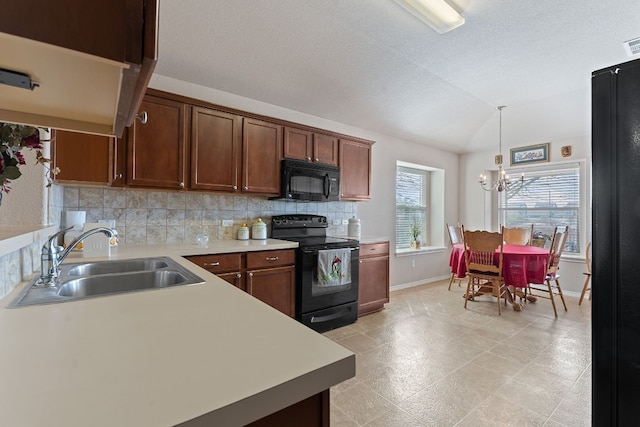 kitchen featuring sink, vaulted ceiling, pendant lighting, decorative backsplash, and black appliances