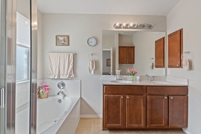 bathroom featuring vanity, a bathtub, and tile patterned floors