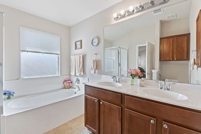 bathroom with tile patterned floors, shower with separate bathtub, and vanity