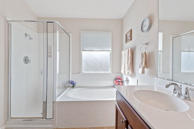 bathroom featuring vanity and shower with separate bathtub