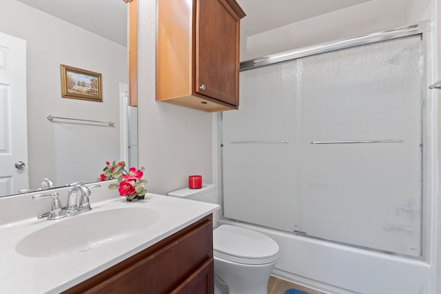 full bathroom with toilet, vanity, shower / bath combination with glass door, and tile patterned flooring