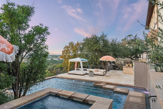 4908 Mirador Dr, Austin, TX 78735 - pool at dusk featuring outdoor lounge area, a patio area, an outdoor pool, and an in-ground hot tub